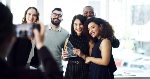 Woman,,Team,And,Photo,With,Award,At,Office,For,Goals,